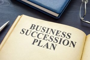 Open business succession plan on the wooden surface. 