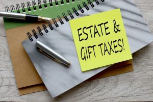 Estate Gift Taxes! top view of text on green sticky note.