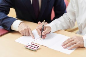 Hands of elderly people who consult with the profession about trusts and wills 