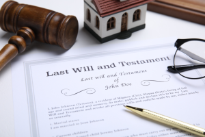 Last will and testament document with pen on white table, close-up view. 