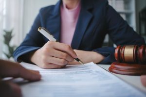 Estate planning attorney reviewing and signing a will with client