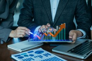 Selective focus of business team meeting with financial graphs and data on office table, representing finance, accounting, and content marketing.