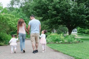 Mixed race family together in park