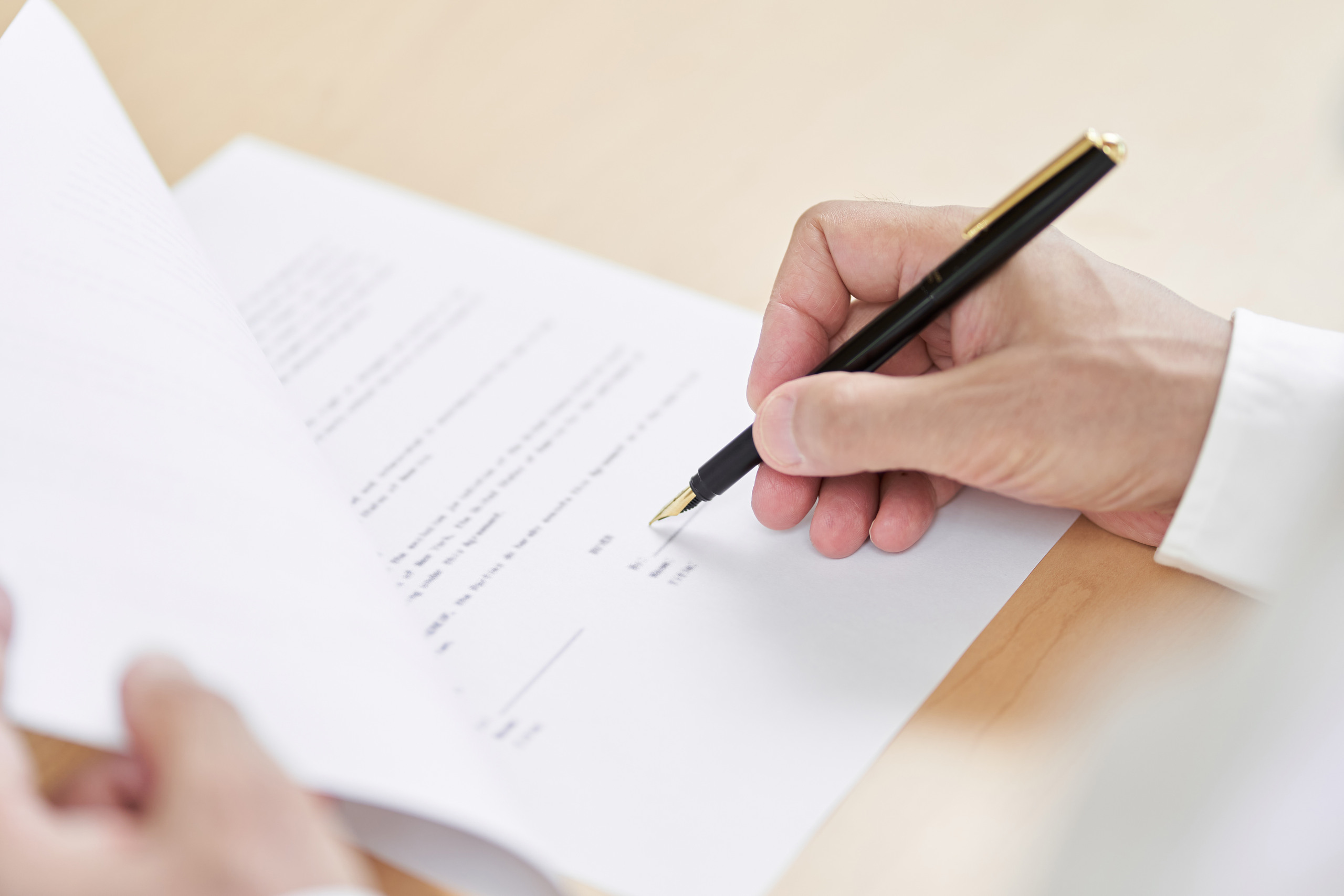 Signing estate planning documents with Coral Gables living will lawyers.