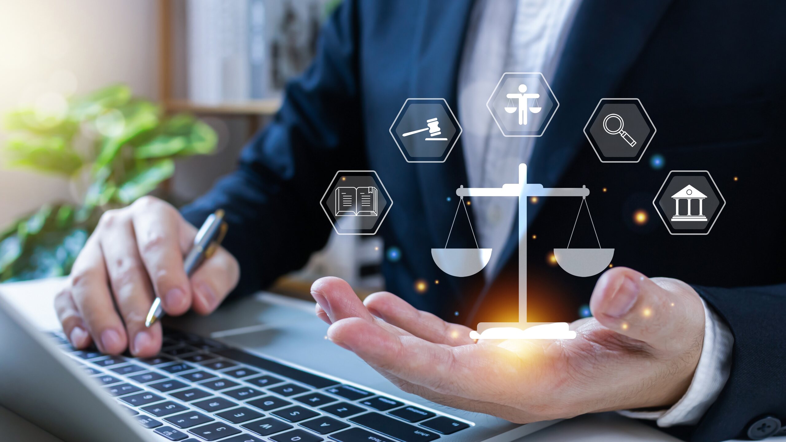 Attorney holding a digital scales of justice icon over a laptop representing Coral Gables probate attorneys.